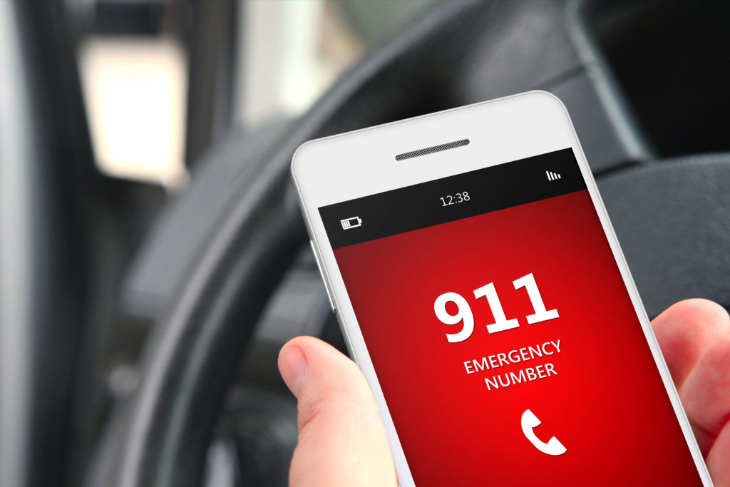 hand holding cellphone with emergency number 911