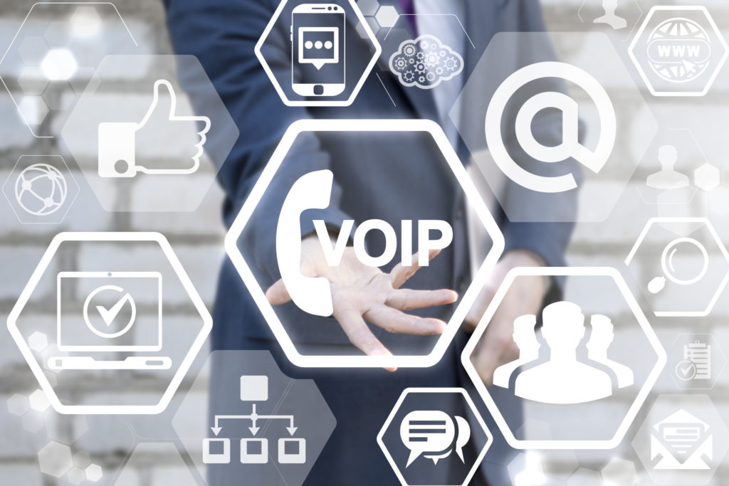 Man offers voip handset icon on a virtual digital screen interface. VOIP Global Communications Connectivity Business Information Web Technology. Voice over IP - phone internet call concept.