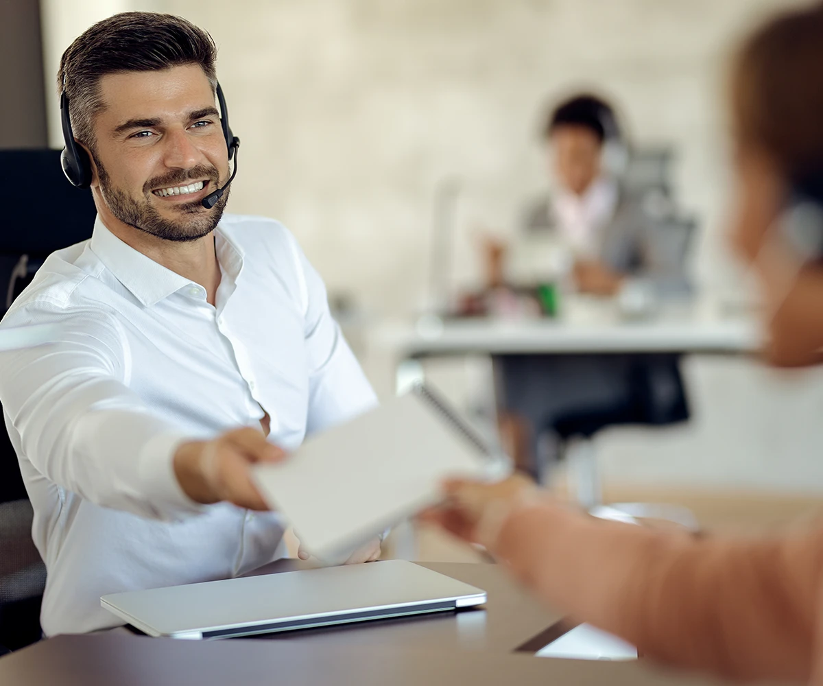 happy-businessman-cooperating-with-his-colleague-while-working-office